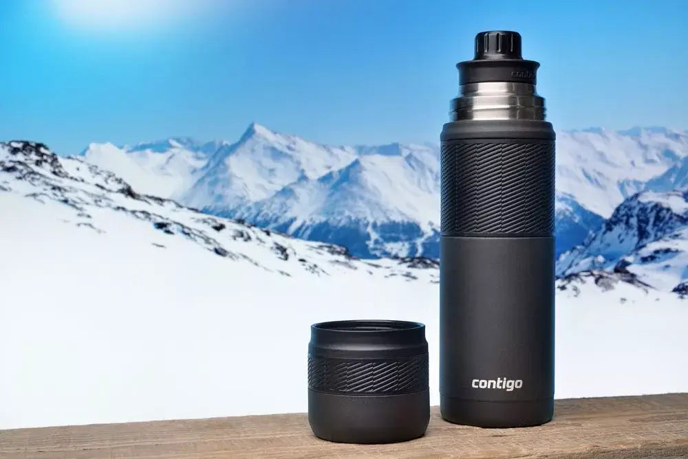 Contigo water tumbler set in snow-covered mountains, featuring a large tumbler and a smaller cup, ideal for outdoor adventures.