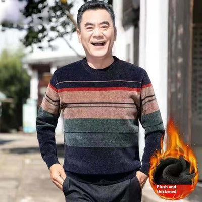 Middle-aged man smiling in a stylish, striped, winter fleece-lined sweater outdoors.