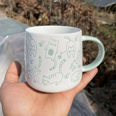 Ceramic mug featuring chubby cats and playful designs, perfect for cat lovers, capacity 340ml.