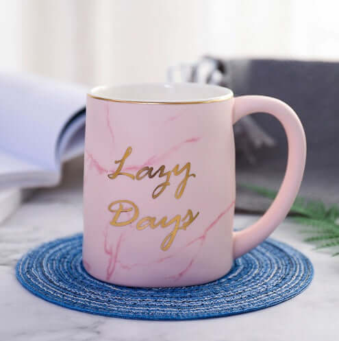 Pink marble grain ceramic coffee mug with gold lettering 'Lazy Days', perfect for coffee, tea, or gifts.