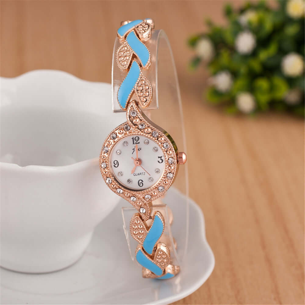 Trendy quartz watch with multi-color leaf design, featuring a rose gold dial and decorative band by BONEHEAD PRO-CREATIONS.