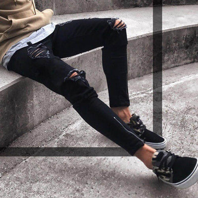 Stylish men's skinny jeans with ripped detailing, paired with trendy sneakers, ideal for casual outings.