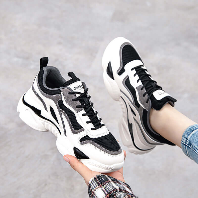 Stylish breathable black and white platform sneakers for casual wear, featuring modern design and durable materials.