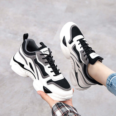 Stylish breathable black and white platform sneakers for casual wear, featuring modern design and durable materials.