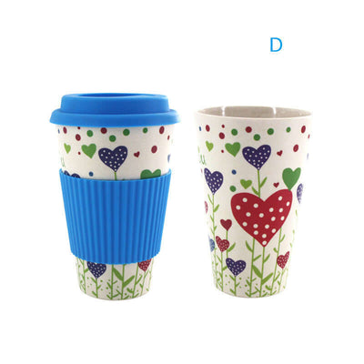 Colorful bamboo fiber water cup with blue silicone lid and sleeve, featuring a floral heart design.