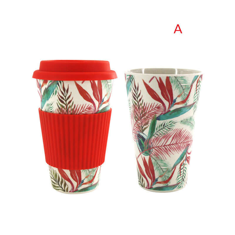 Eco-friendly bamboo fiber water cup with colorful tropical leaf design and red silicone lid and grip.