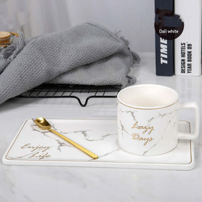 Marble grain ceramic coffee mug on white tray with gold spoon, perfect for office or home use.