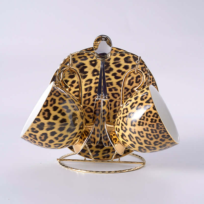 Leopard print porcelain coffee mugs and saucers set with gold accents, showcasing luxury drinkware in stylish design.