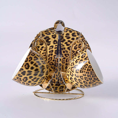 Leopard print porcelain coffee mugs and saucers set with gold accents, showcasing luxury drinkware in stylish design.