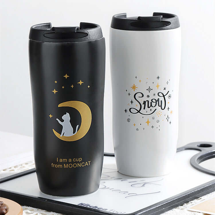Cute black and white travel mugs featuring a cat and starry designs, ideal for coffee lovers and stylish drinkware.