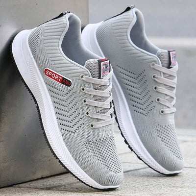 Breathable gray mesh sports shoes with lace-up design for men, ideal for casual wear and running.