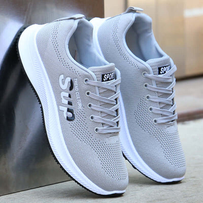 Breathable gray mesh sports shoes with lace-up design and rubber sole, perfect for casual wear and running by BONEHEAD PRO-CREATIONS.
