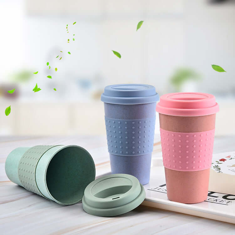 Eco-friendly water cups in pastel colors with silicone caps, showcasing wheat straw material and unique dotted texture.