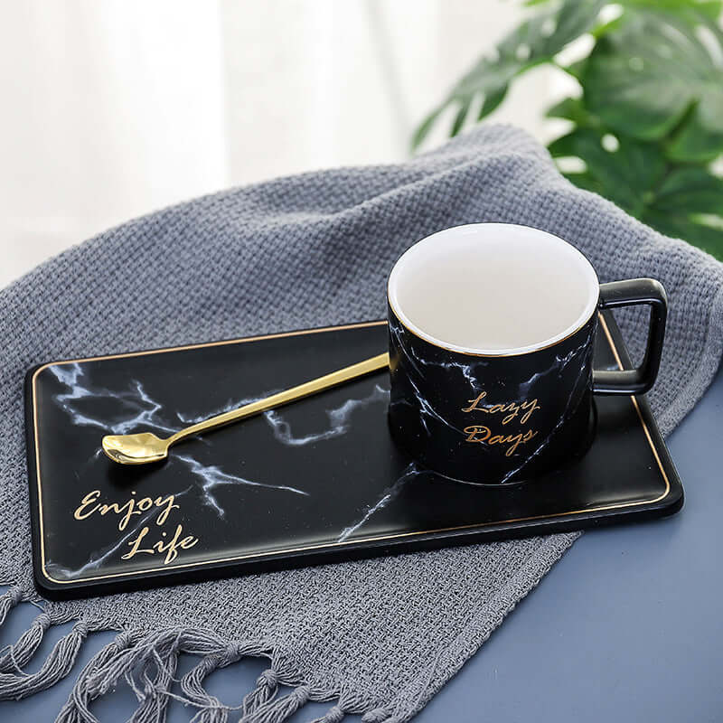 Black marble grain ceramic coffee mug and plate set with gold accents and spoon, perfect for office or home use.