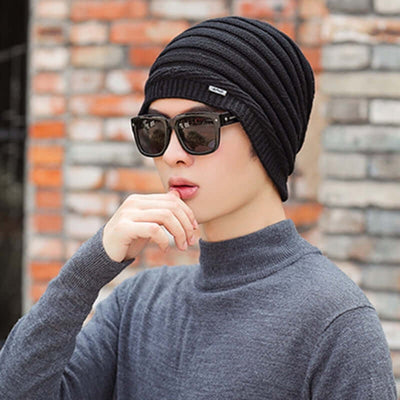 Fashionable black dome cap with ribbed texture, paired with stylish sunglasses, highlighting trendy winter accessories.