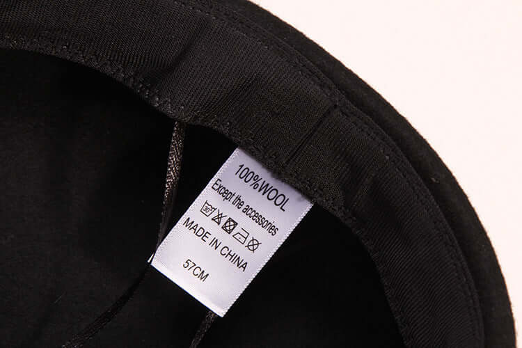 Interior label of a women's high-end wool baseball cap, indicating 100% wool material, size 57cm.