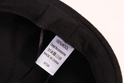 Interior label of a women's high-end wool baseball cap, indicating 100% wool material, size 57cm.