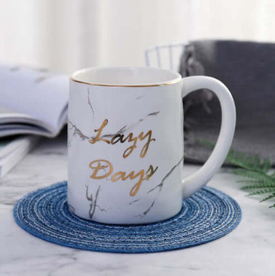 Marble grain ceramic coffee mug with gold lettering 'Lazy Days', perfect for office or home use.