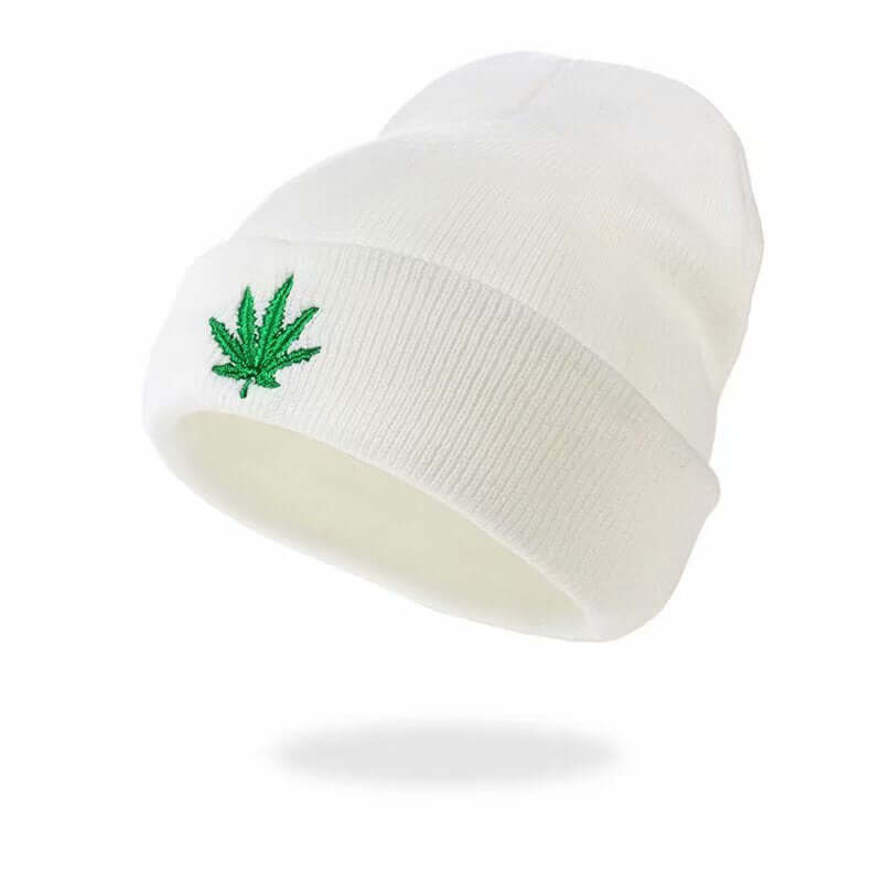 White knitted beanie with green marijuana leaf embroidery, perfect for urban fashion enthusiasts and cold weather wear.