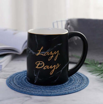 Black marble grain ceramic coffee mug with gold text 'Lazy Days', ideal for coffee, tea, or as a gift for home or office.
