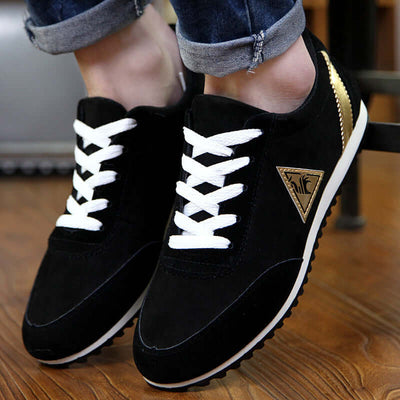 Black and gold low-top sneakers with white laces, designed for comfort and style.