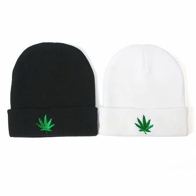 Black and white knitted beanie hats featuring green embroidered cannabis leaf design, perfect for hip hop style.