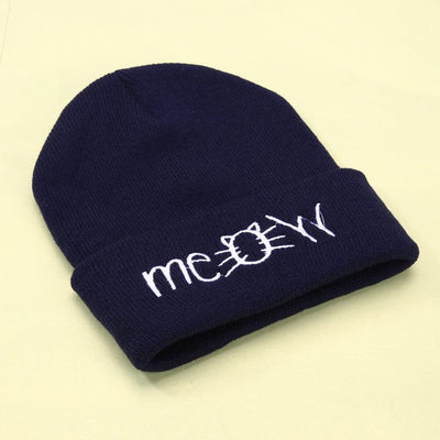 Navy blue knitted beanie hat with embroidered 'meow' design for casual winter wear.