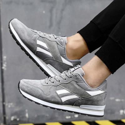 Men's casual gray running shoes with white stripes, featuring mesh and rubber sole, perfect for everyday wear.
