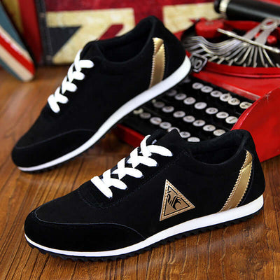 Black BONEHEAD PRO-CREATIONS shoes with gold accents and white laces on a wooden floor.