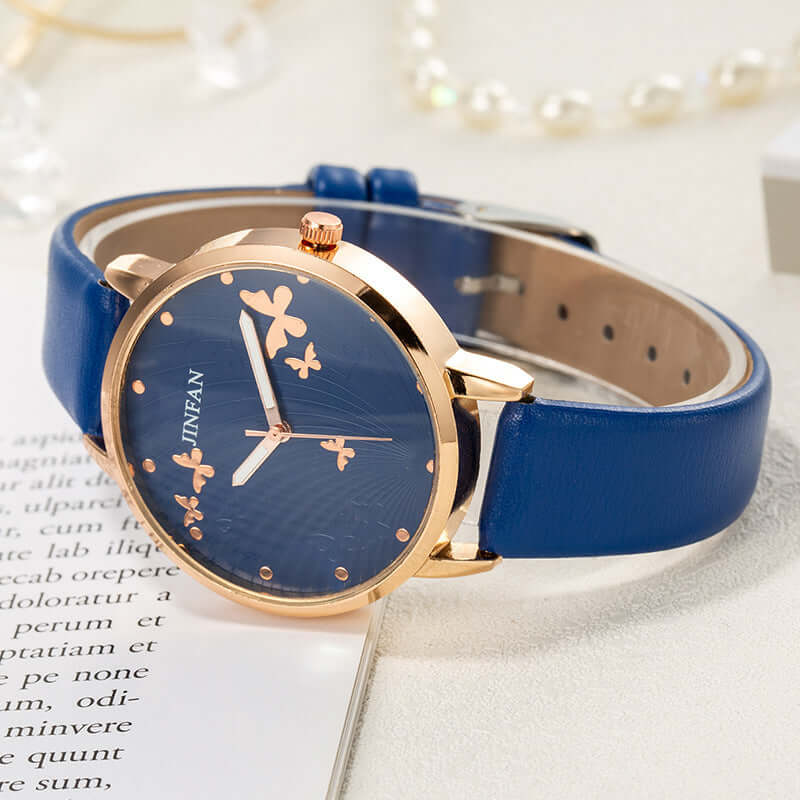 Casual student butterfly wrist watch by BONEHEAD PRO-CREATIONS with blue imitation leather strap and elegant floral design.