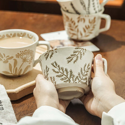 Hand-painted minimalist Nordic ceramic mug with floral design, perfect for enjoying beverages and enhancing home decor.