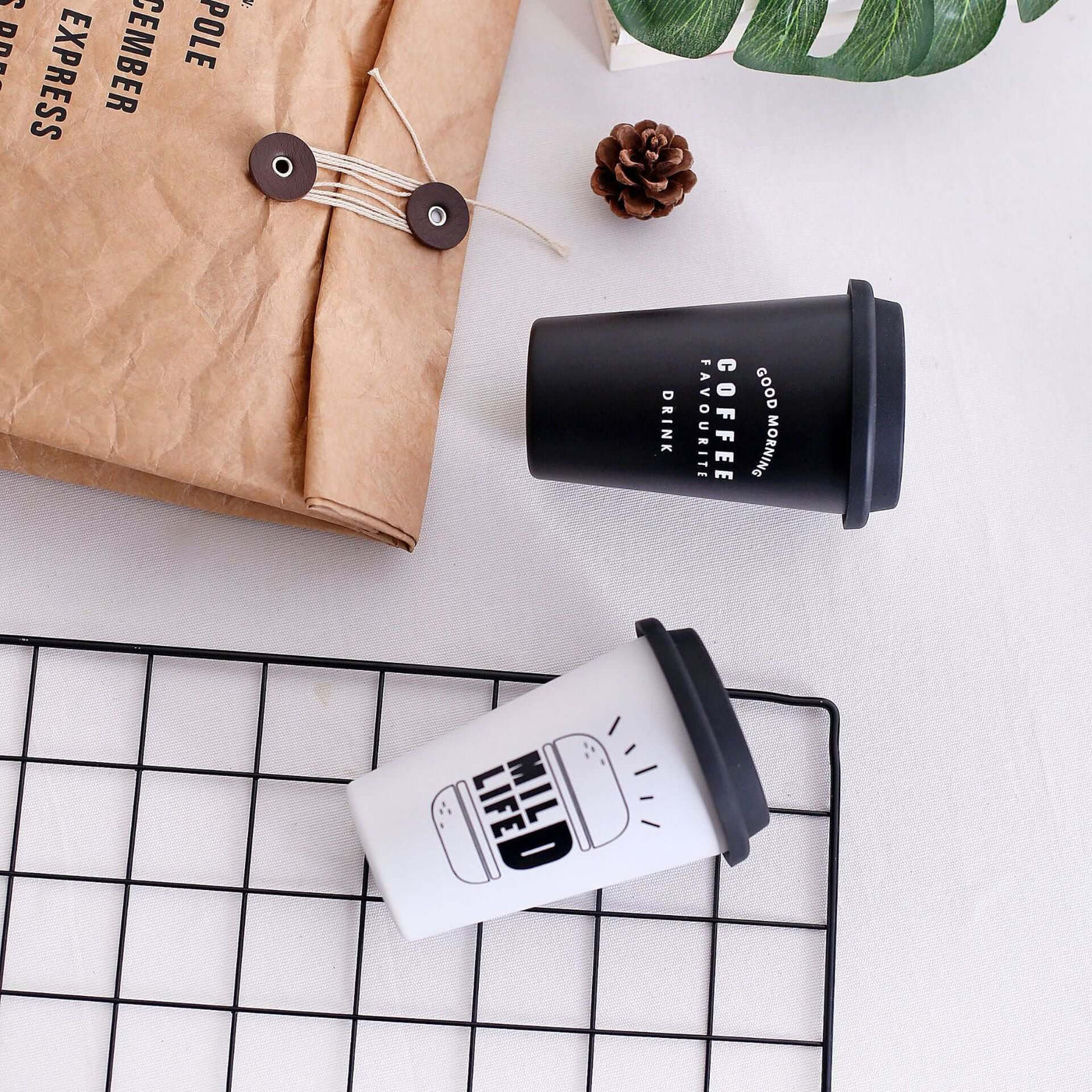 ROKEN stainless steel cups in black and white on a table; BPA free, 350ML, ideal for kids and adults.
