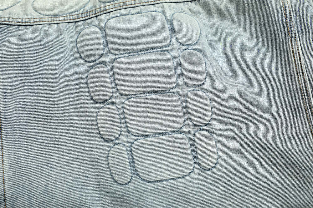 Distressed denim jacket with skull art for men