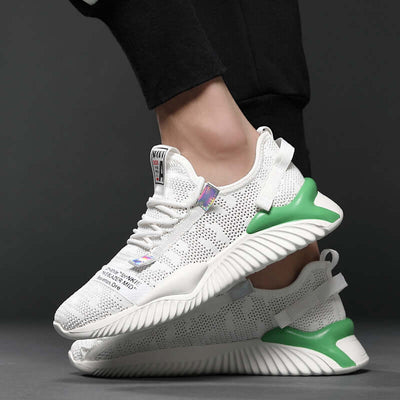 Breathable white mesh shoes for men with green accents and rubber sole, stylish and comfortable for casual wear.