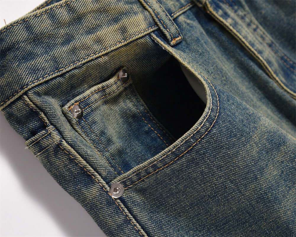 Close-up of dark blue denim pocket jeans for men, showcasing the fabric and stitching details.