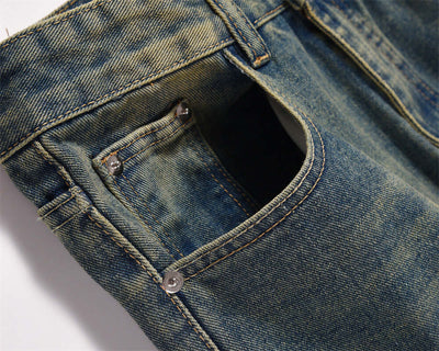 Close-up of dark blue denim pocket jeans for men, showcasing the fabric and stitching details.