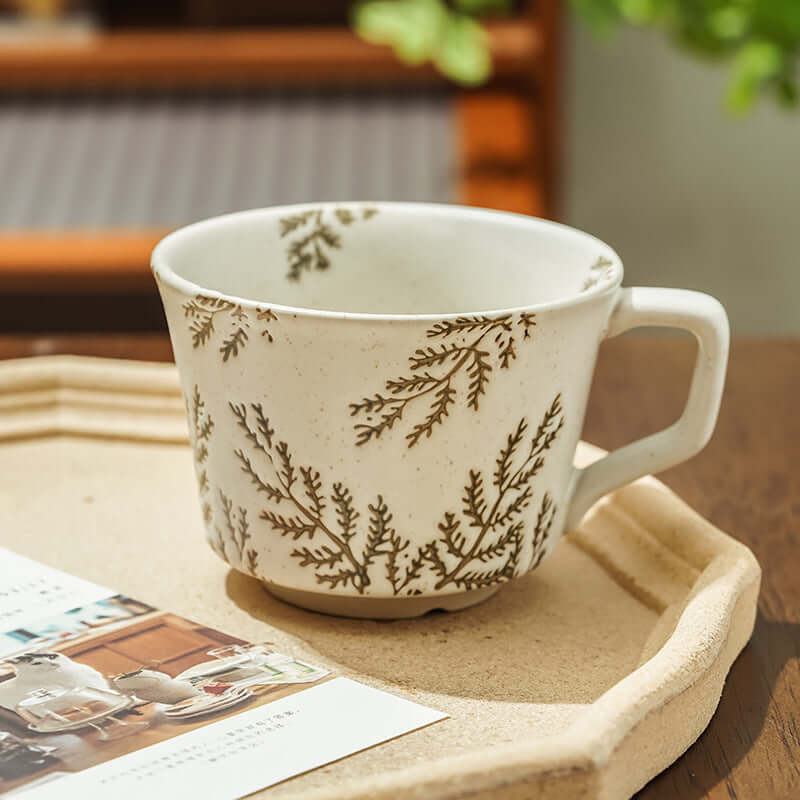 Hand-painted Nordic ceramic mug with botanical design, perfect for minimalist home decor.