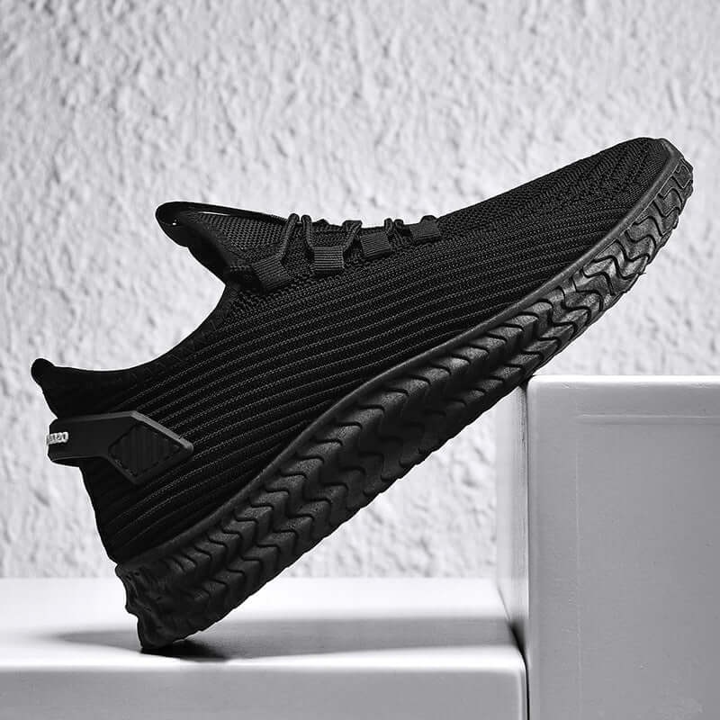 Men's casual summer shoes from BONEHEAD PRO-CREATIONS, featuring a breathable black flying weave upper and flat rubber sole.
