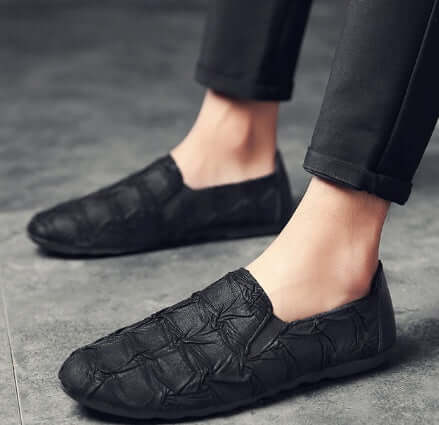 Men's black slip-on shoes with textured design, perfect for casual wear, lightweight and comfortable.