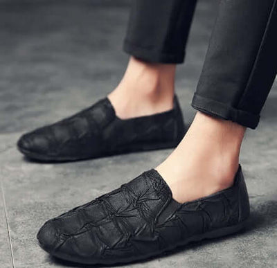Men's black slip-on shoes with textured design, perfect for casual wear, lightweight and comfortable.