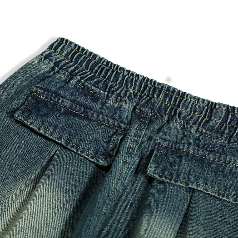 Close-up of the waistband and back pockets of men's fashion denim trousers in blue.