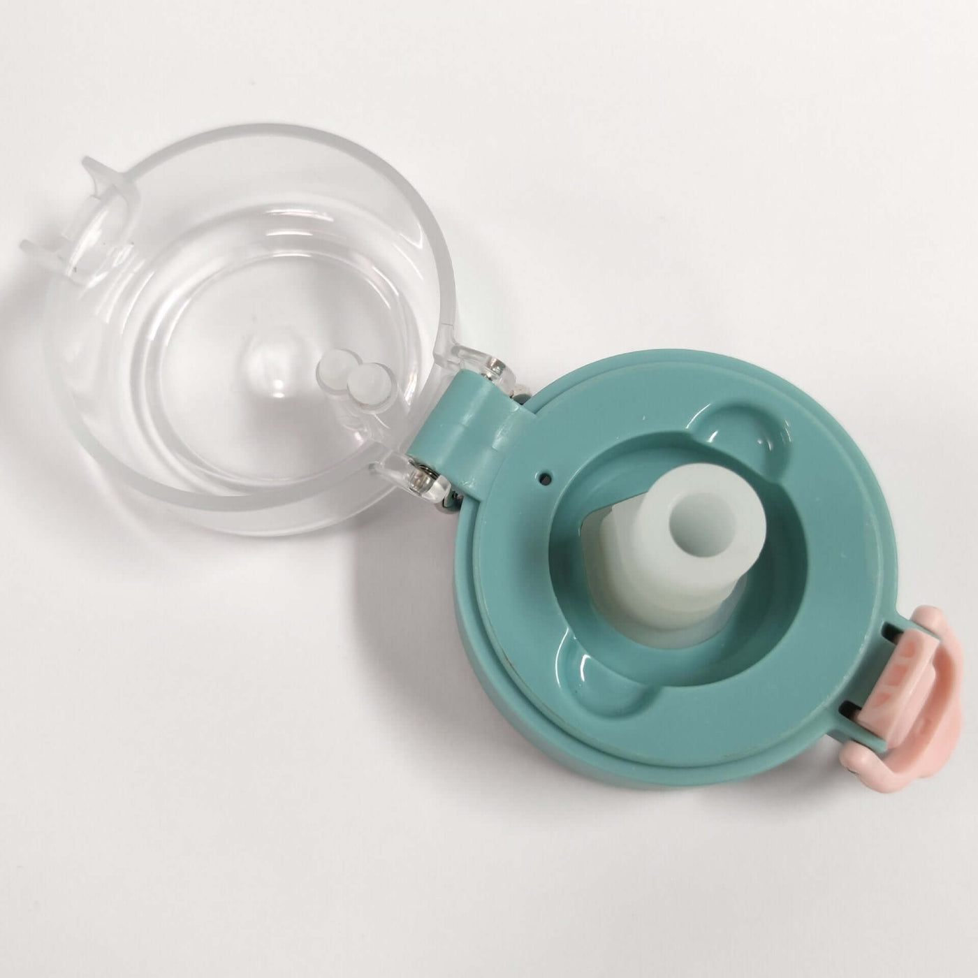 Close-up of a teal drinking water bottle cap with a transparent lid and spout, stylish design for easy access.