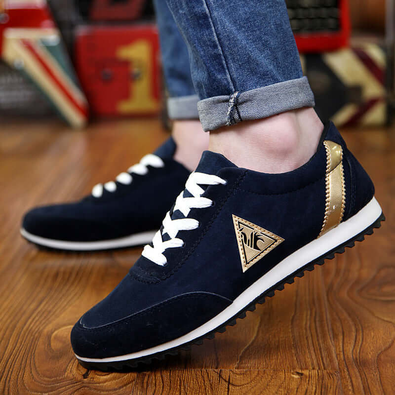Men's navy blue sneakers with white laces and gold accents, ideal for casual wear and comfortable performance.
