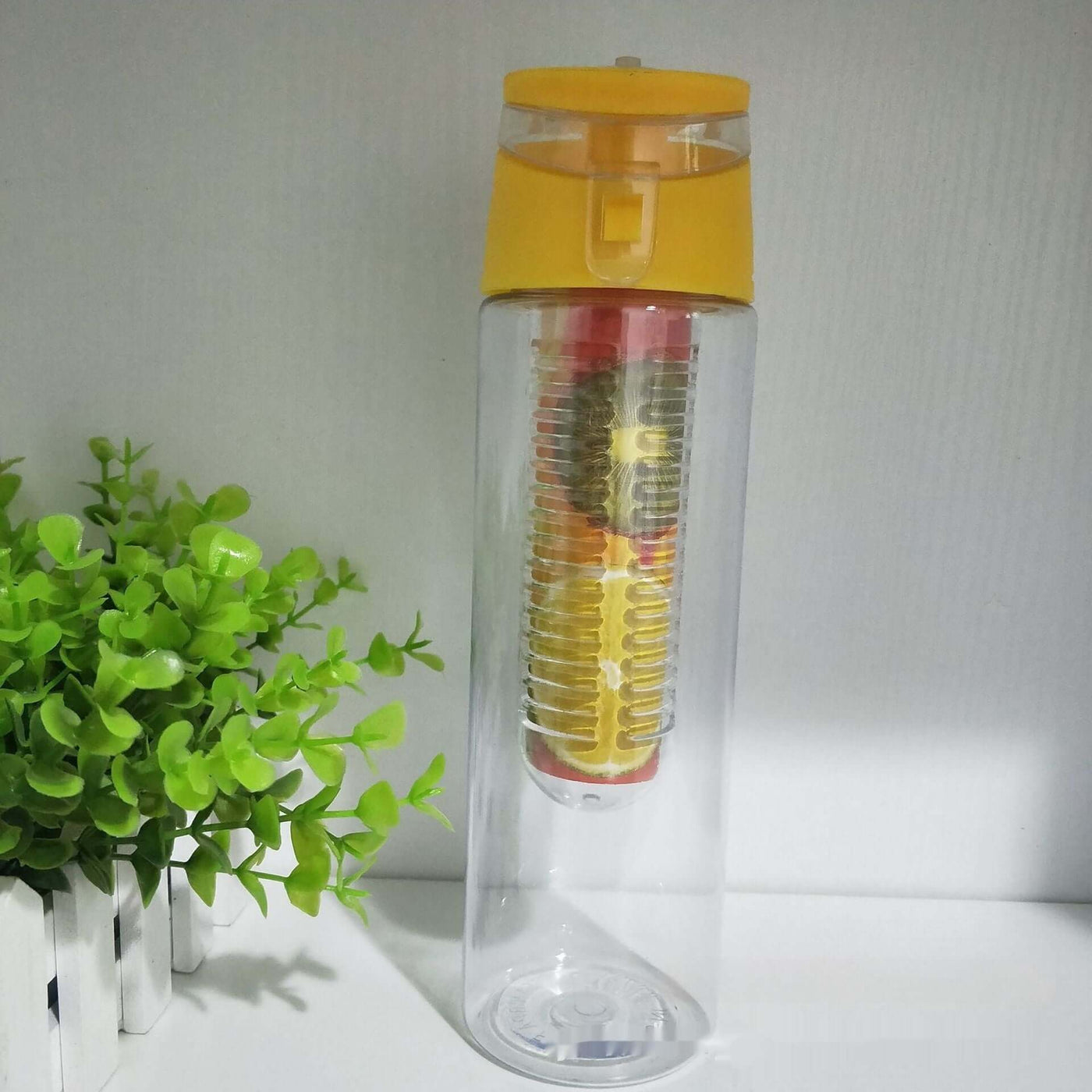 Clear plastic water bottle with yellow lid and built-in tea steeper, perfect for outdoor sports and infused lemon water.