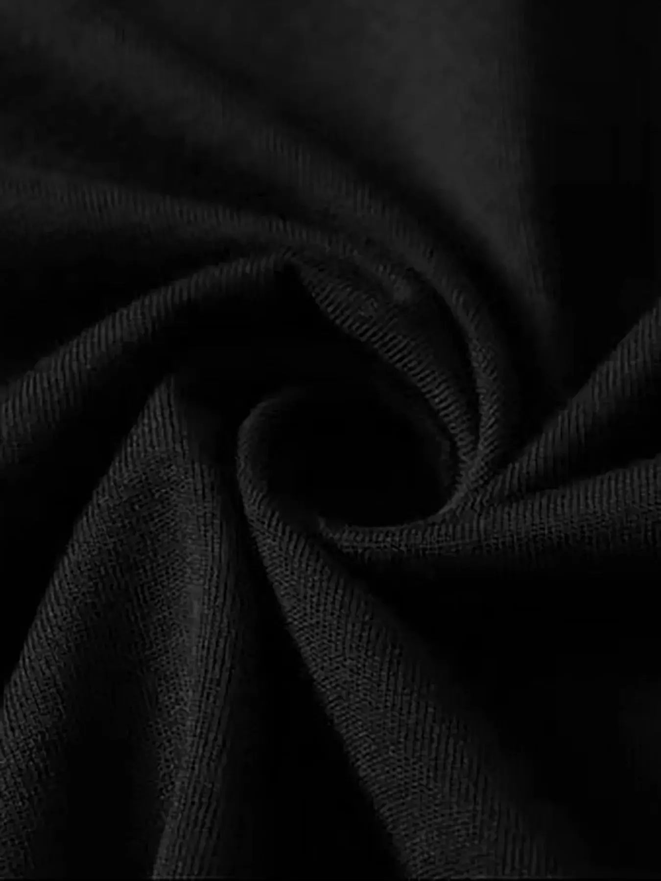 Close-up view of soft black cotton fabric, showcasing its smooth texture and slight stretch for comfortable wear.