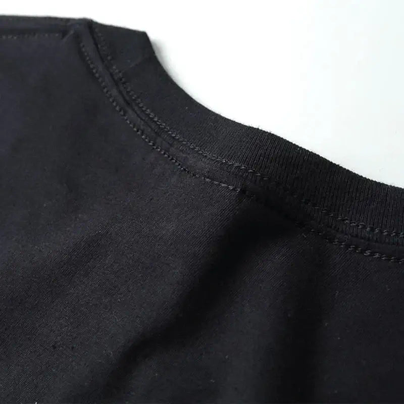 Close-up of the collar on a black AEW ALL IN live T-shirt, showcasing high-quality knit fabric and detailed stitching.