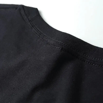 Close-up of the collar on a black AEW ALL IN live T-shirt, showcasing high-quality knit fabric and detailed stitching.