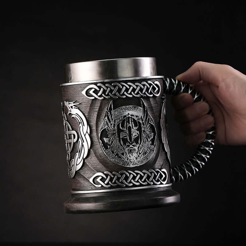God of War inspired stainless steel beer mug with Viking motif and braided handle, 600ml capacity.