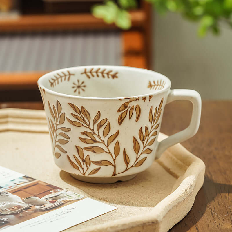 Hand-painted minimalist Nordic ceramic mug with leaf design on a wooden tray, perfect for modern home decor.