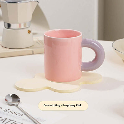 Ceramic mug in raspberry pink with purple handle, 300ml capacity, styled on a playful coaster.
